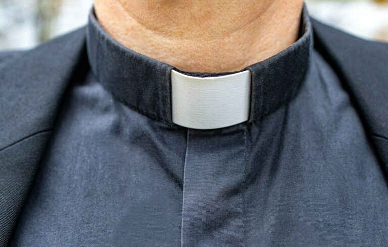 a close up of a man wearing a neck tie