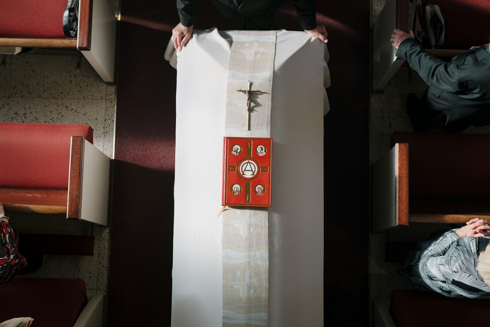 A priest prepares a church altar for service.
