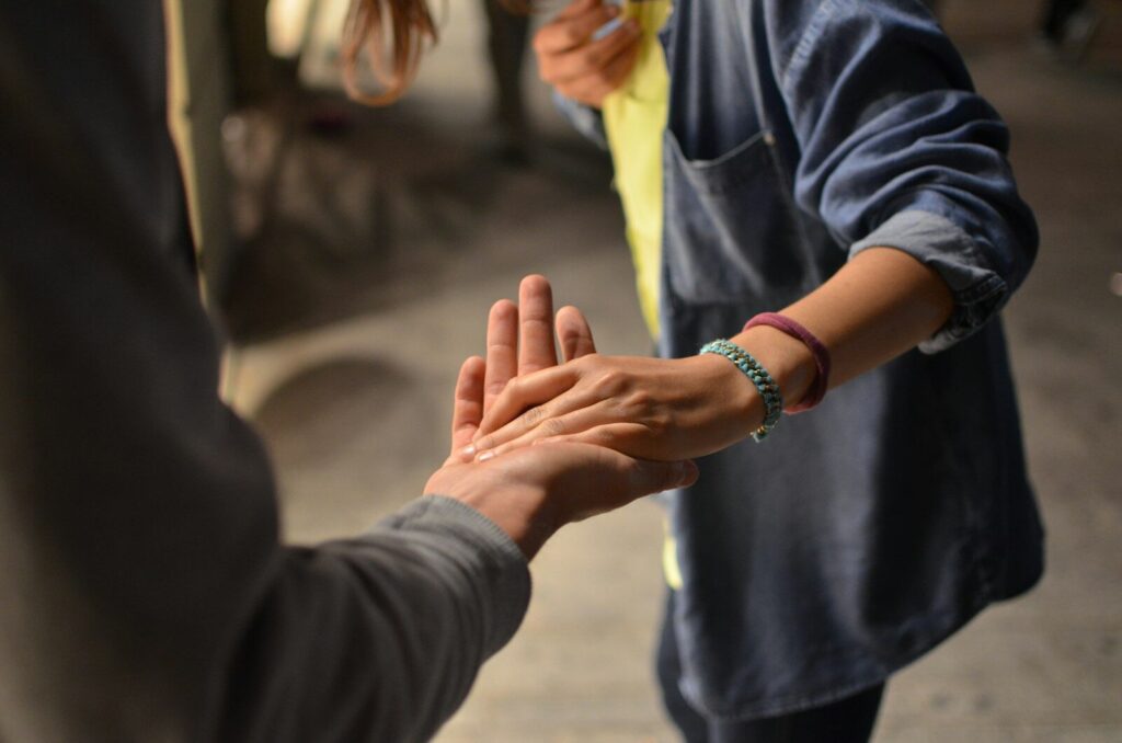 two hands meeting palm to palm